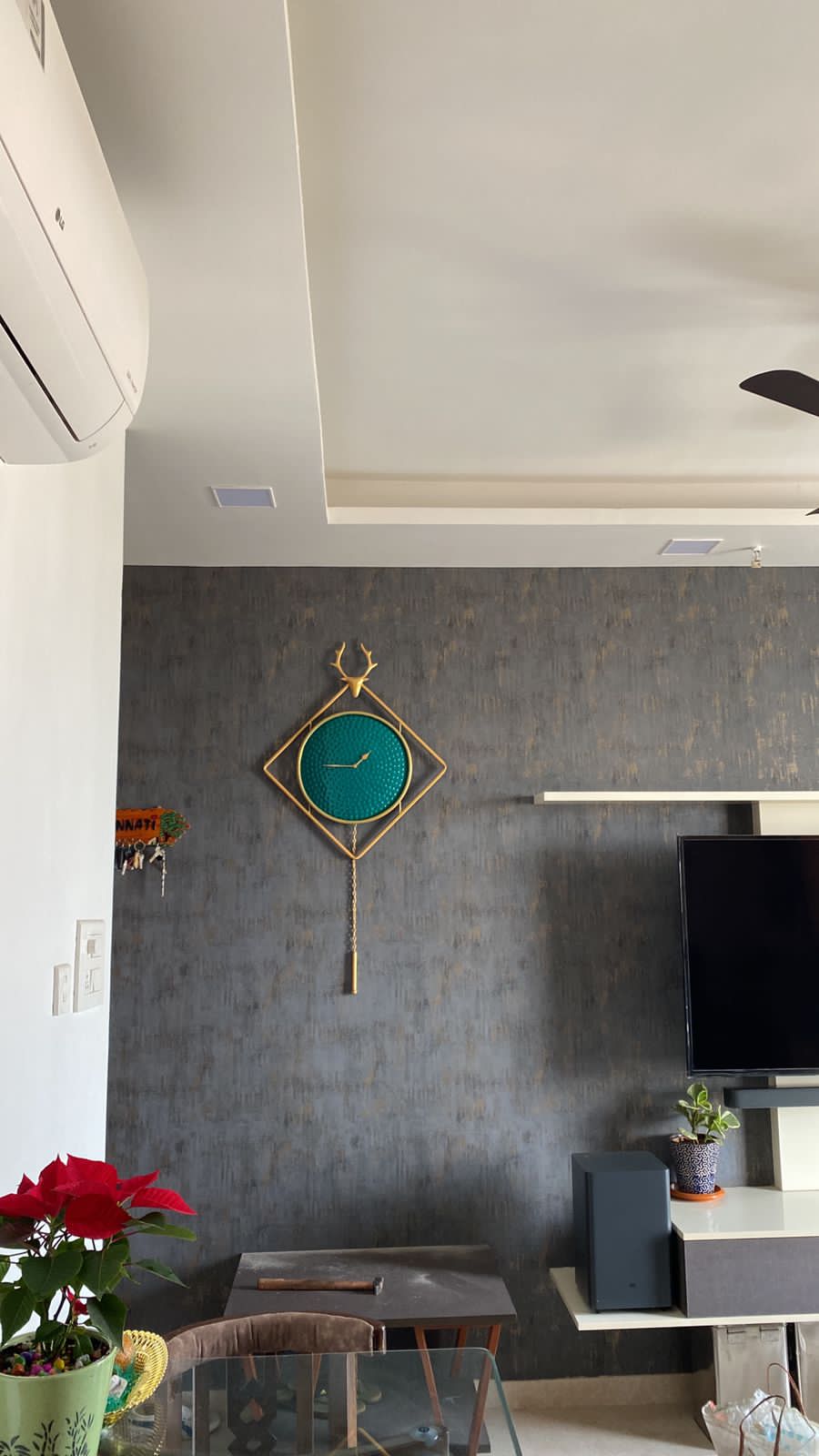 Gold & Sky Blue Metal Wall Clock – clock installed in a room