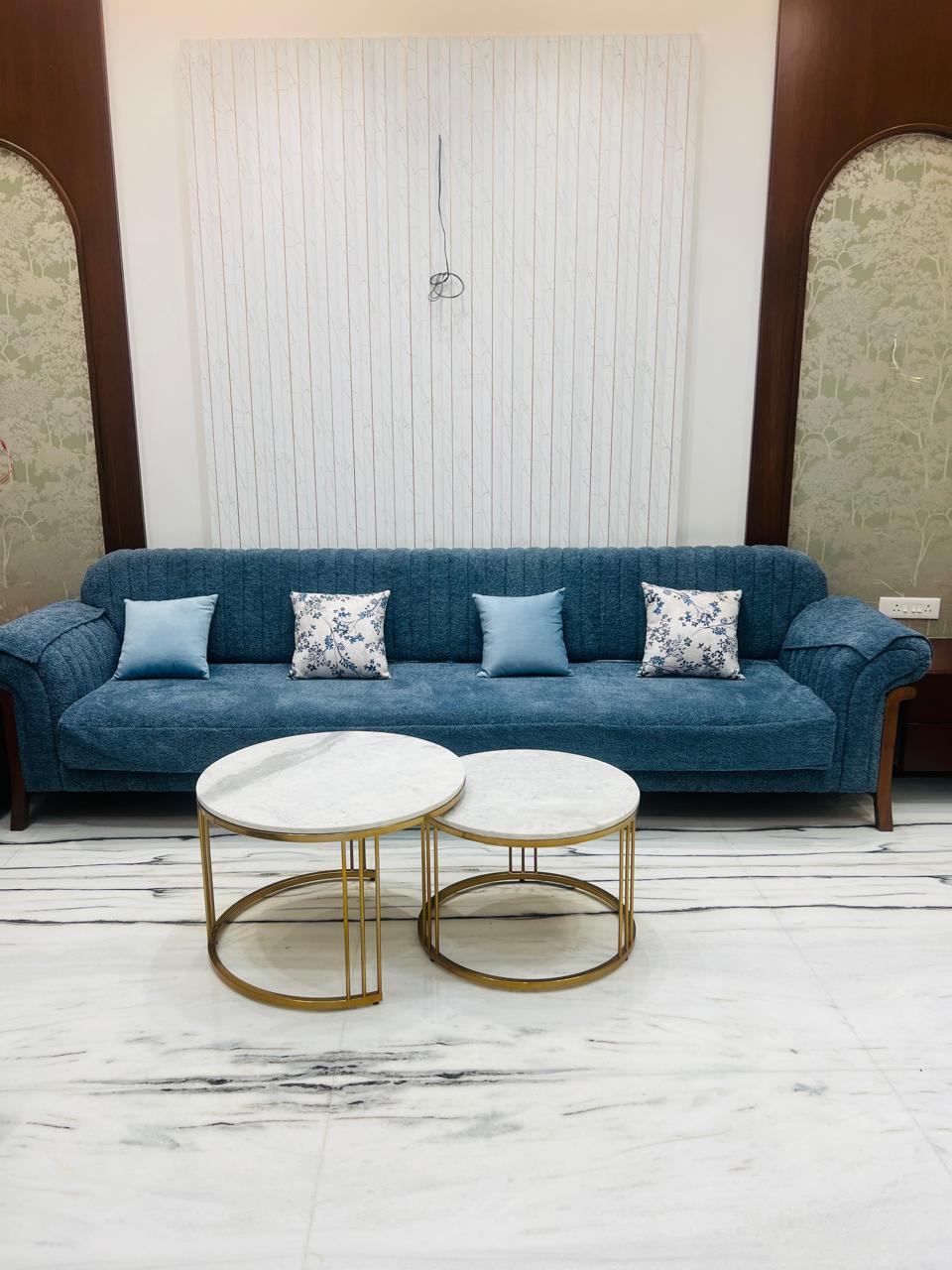 Aria Round Marble Nesting Coffee Tables – round tables in front of a blue sofa