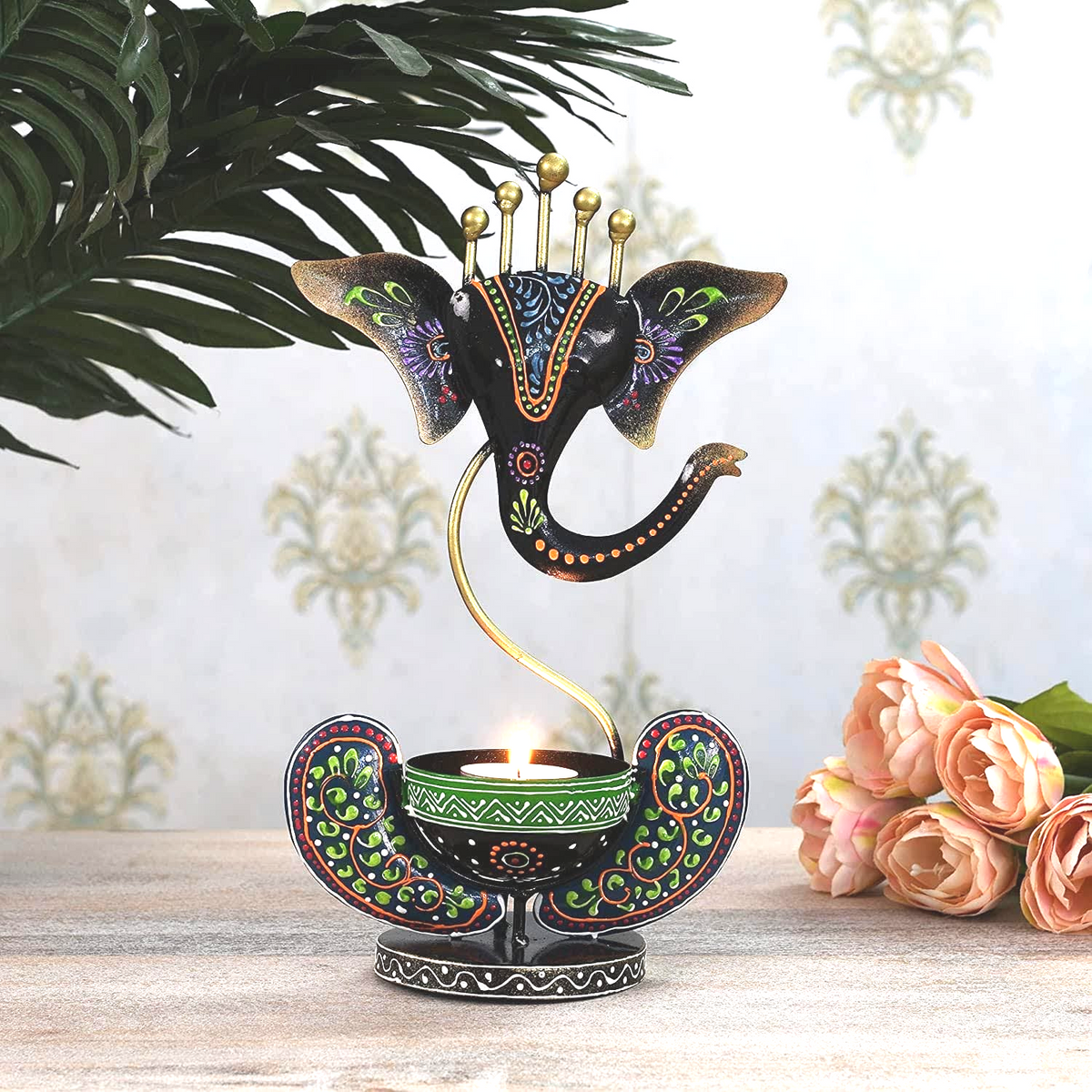 Multicolour Ganesha Tea Light Holder – black Ganesha holder beside greenery