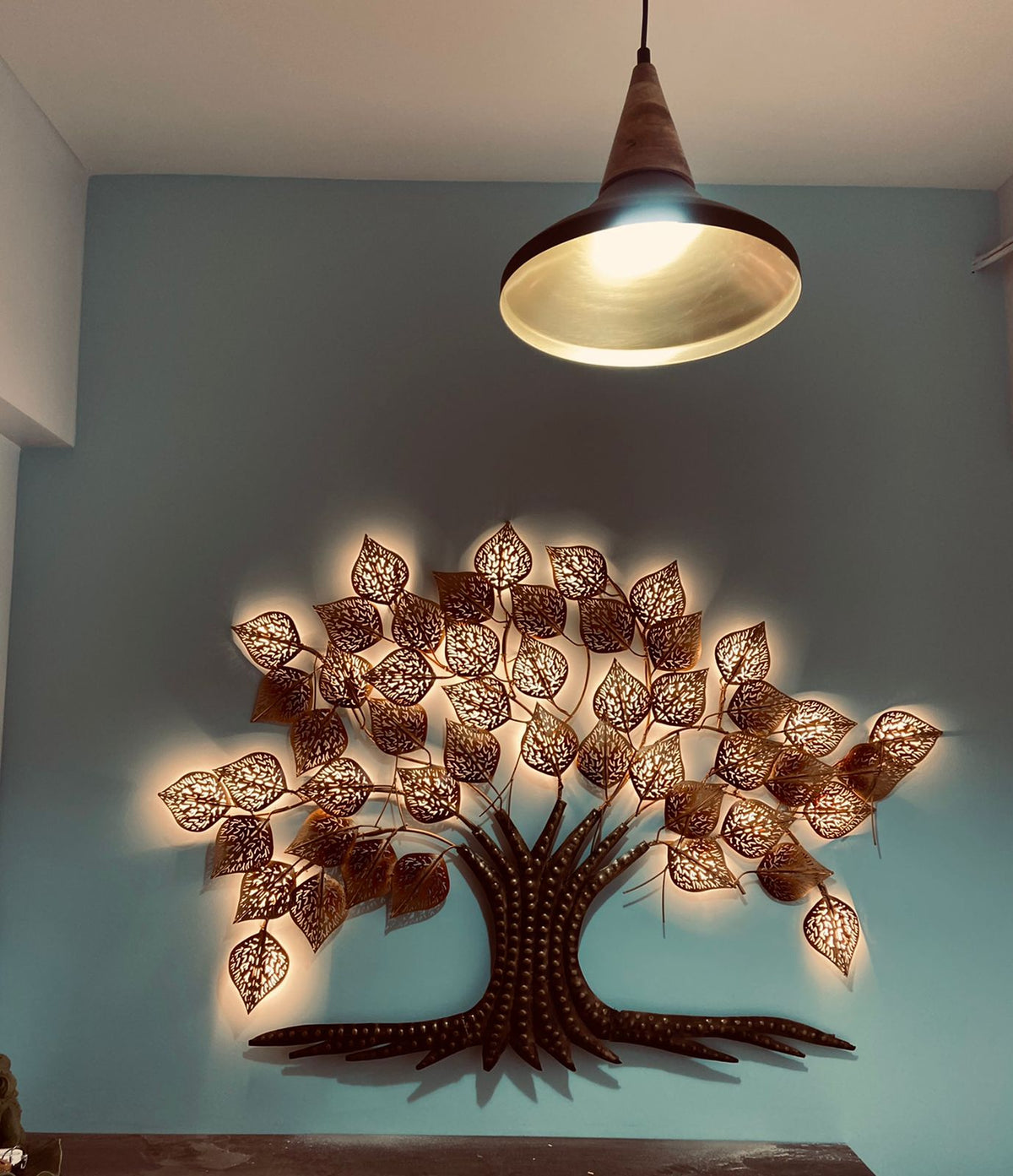 Ethnic tree wall décor – wall display beneath a pendant lamp