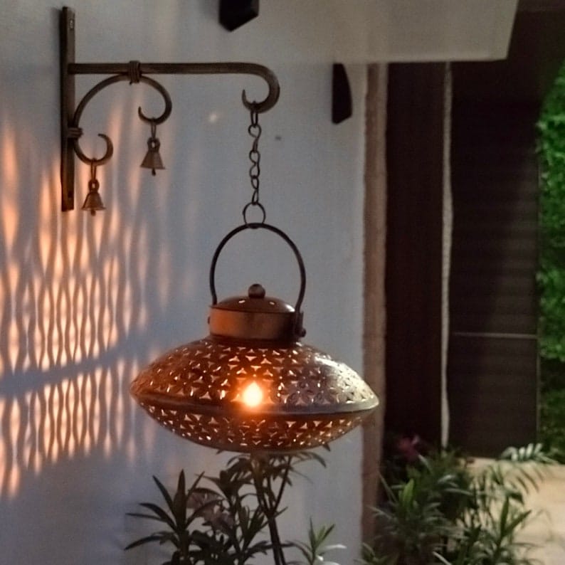 Gold Wall Décor Tea Light Holder – lit lantern casting patterned light