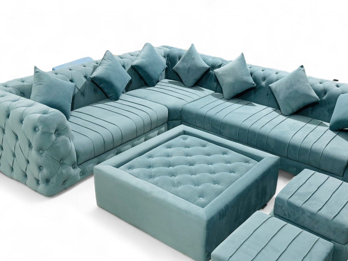Blue Velvet Sofa Set with Table & Ottomans – angled view of tufted seating and table